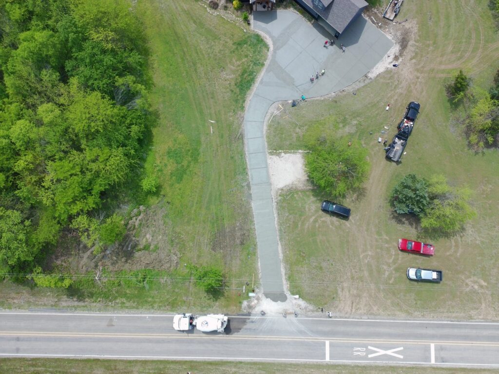 Aerial view of a new concrete driveway from the road to the house in Denison, TX