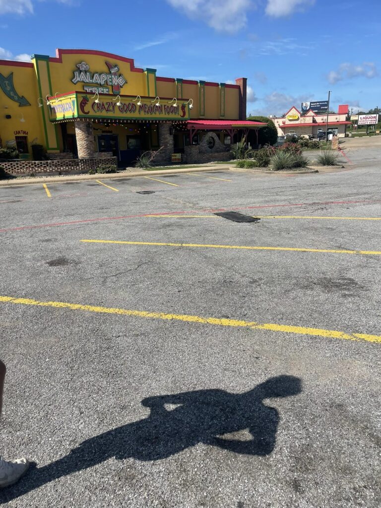 Finished asphalt patches in a restaurant parking lot in Denison, TX