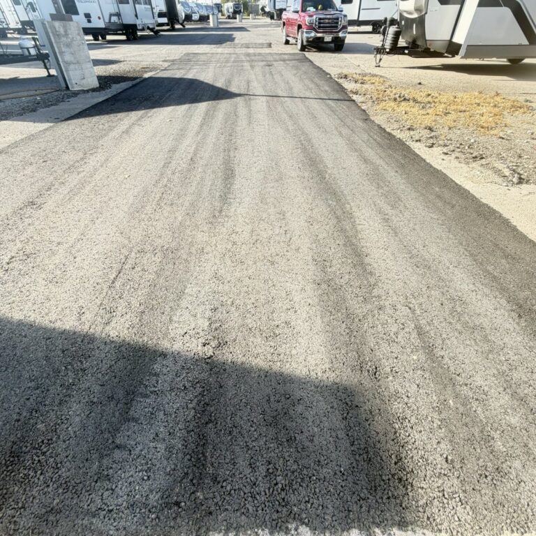 Long asphalt patch repair in a dealership lot in Sherman, TX