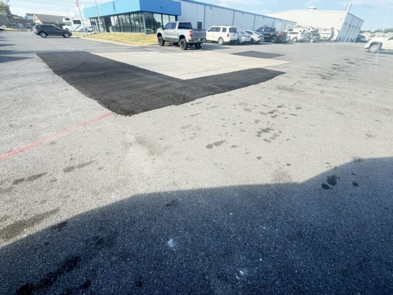Asphalt patch repair in a dealership parking lot in Sherman, TX
