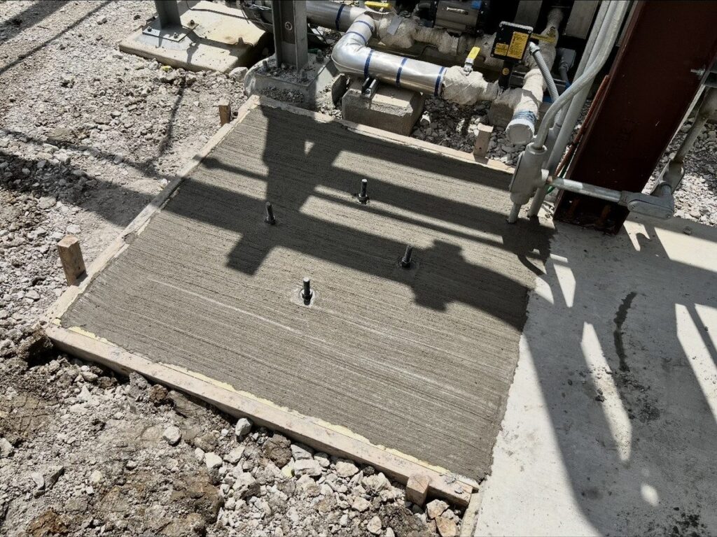 New concrete equipment pad with anchor bolts at a landfill site near Whitesboro, TX